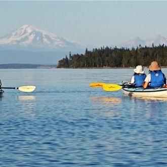 kayakers with snowy mountain