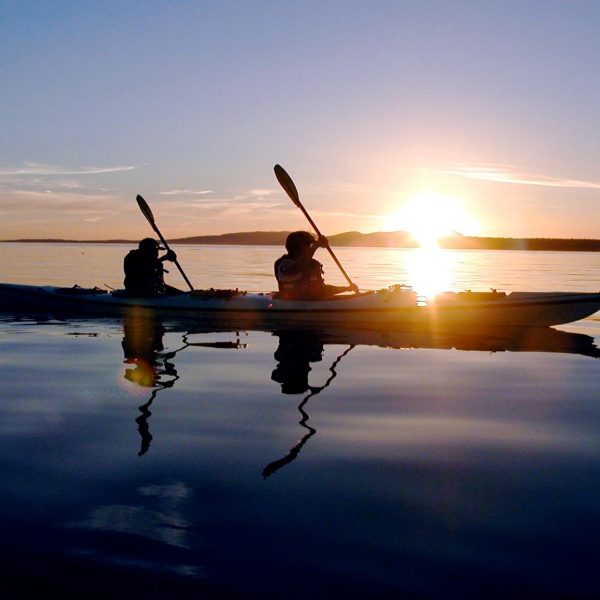 2 people in a kayak at sunset