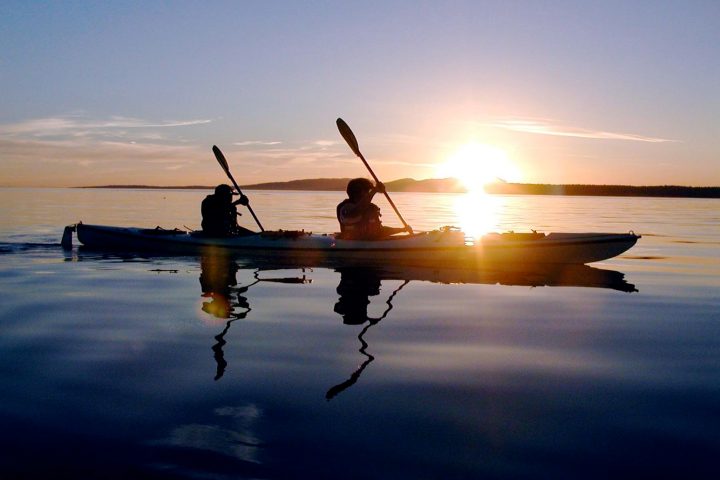 2 people in a kayak at sunset