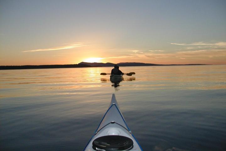 kayakers at sunset