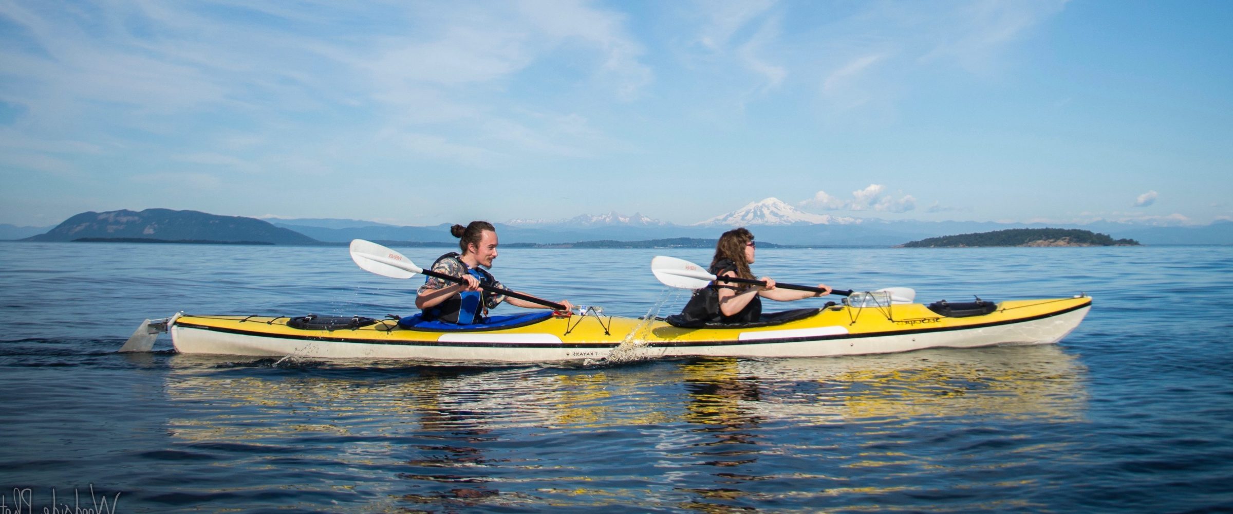man and woman in tandem kayak