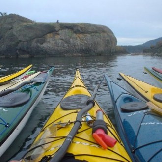 kayaks near a rocky cliff