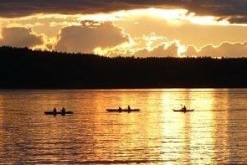 sunset over a group of kayaks