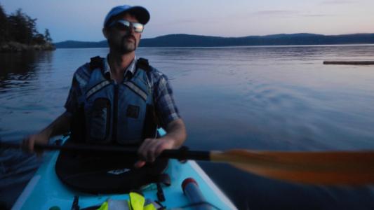 man in a kayak at dusk