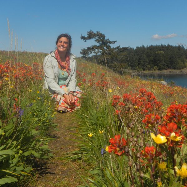 woman kneeling on a flowery path