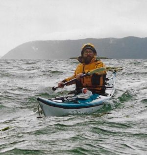 a person riding on the back of a boat in the water