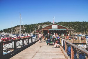 group of people sitting on a dock